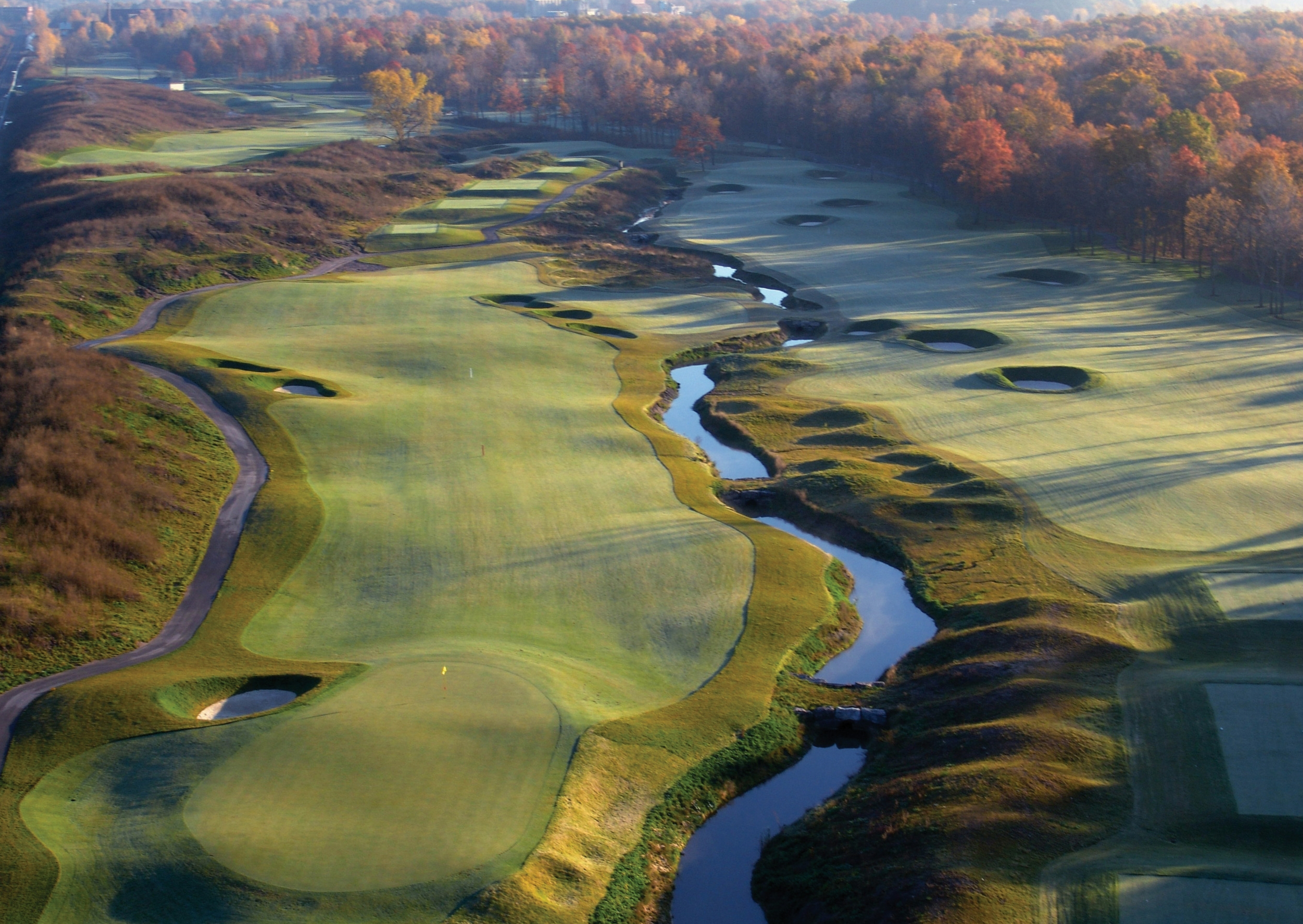 Aerial view of golf course with trickling stream